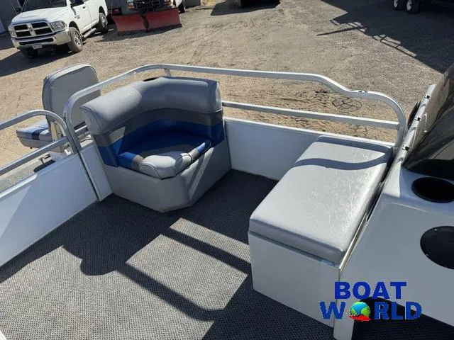 Slide: The Image of 2011 TMC 2200 SE Pontoon boat interior with gray seating and carpeted floor. - 12