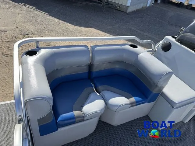 Slide: The Image of 2011 TMC 2200 SE Pontoon boat seating with blue and gray upholstery, featuring cup holders. - 13