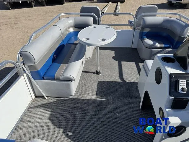 Slide: The Image of 2011 TMC 2200 SE Pontoon interior with seating and table, displayed at Boat World. - 17