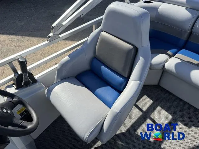 Slide: The Image of Captain's seat on 2011 TMC 2200 SE Pontoon boat, featuring blue and gray upholstery. - 19