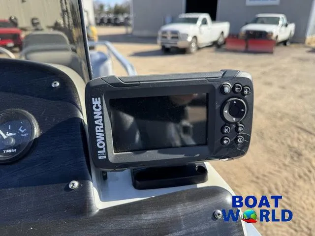 Slide: The Image of Lowrance fish finder on 2011 TMC 2200 SE Pontoon, with trucks in the background. - 22