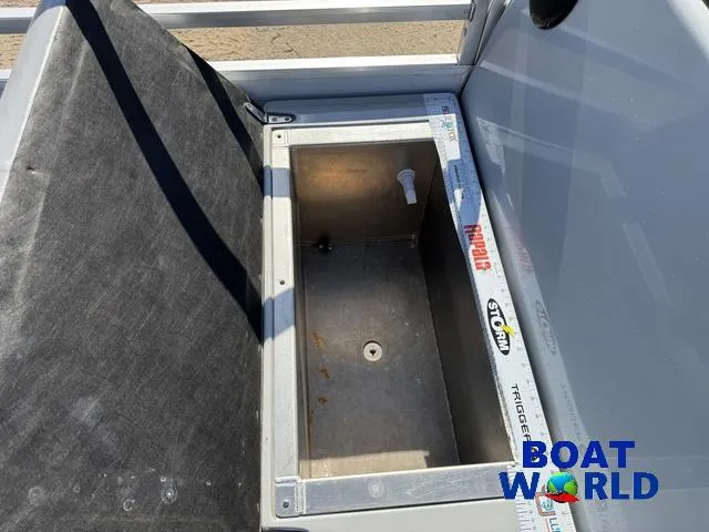Slide: The Image of 2011 TMC 2200 SE Pontoon storage compartment with measuring tape and Boat World logo. - 30