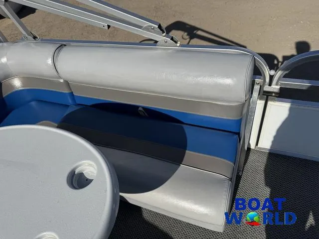Slide: The Image of 2011 TMC 2200 SE Pontoon boat interior with gray and blue seating, table, and Boat World logo. - 32