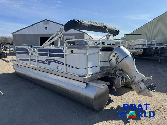 Slide: The Image of 2011 TMC 2200 SE Pontoon boat with Honda motor, parked outdoors at Boat World. - 43