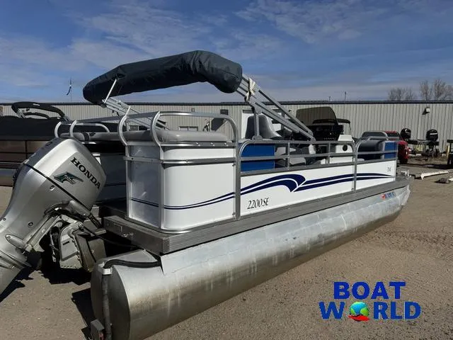 Slide: The Image of 2011 TMC 2200 SE Pontoon boat with Honda outboard motor at Boat World dealership. - 44