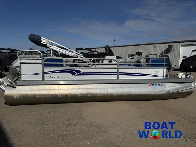 Slide: The Image of 2011 TMC 2200 SE Pontoon boat parked outdoors at Boat World dealership. - 46