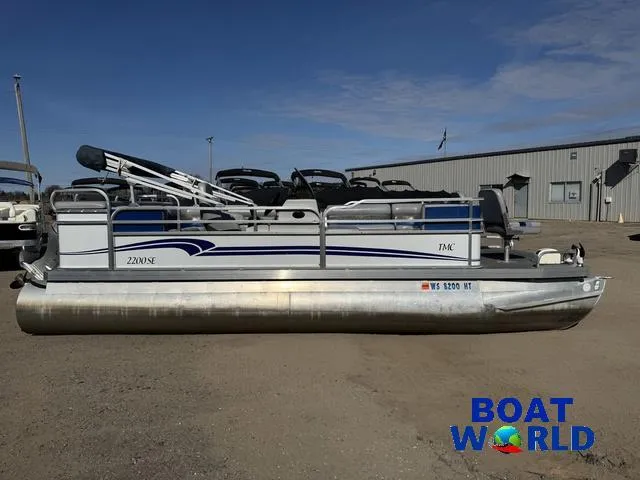 Slide: The Image of 2011 TMC 2200 SE Pontoon boat parked outdoors at Boat World dealership. - 47