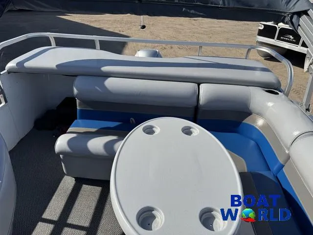 Slide: The Image of 2011 TMC 2200 SE Pontoon boat interior with seating and table, branded "Boat World." - 7