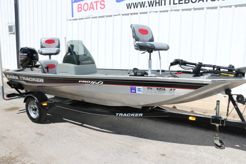 Slide: The Image of 2014 Tracker Pro 160 fishing boat on trailer, parked outside a dealership. - 10