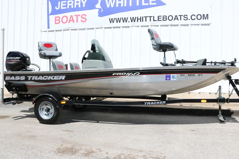 Slide: The Image of 2014 Tracker Pro 160 bass boat on trailer at dealership. - 11