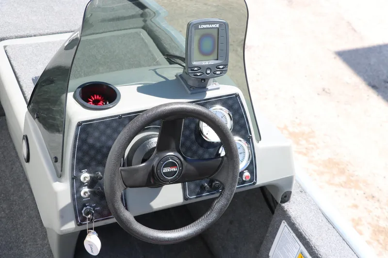 Slide: The Image of 2014 Tracker Pro 160 boat dashboard with steering wheel and Lowrance fishfinder. - 15