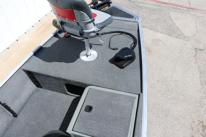 Slide: The Image of 2014 Tracker Pro 160 boat interior with seating and storage compartments. - 16