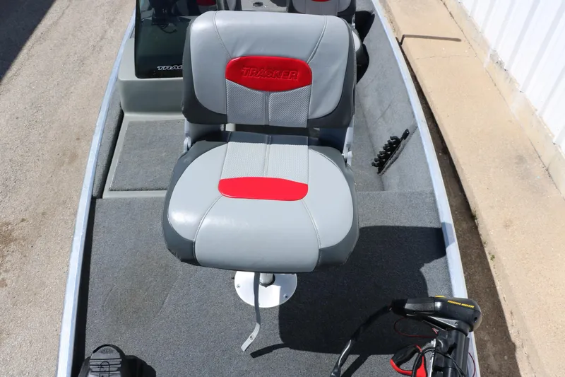Slide: The Image of 2014 Tracker Pro 160 boat seat with red and gray upholstery, viewed from above. - 21