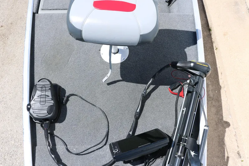 Slide: The Image of 2014 Tracker Pro 160 boat interior with seat, foot pedal, and trolling motor. - 22