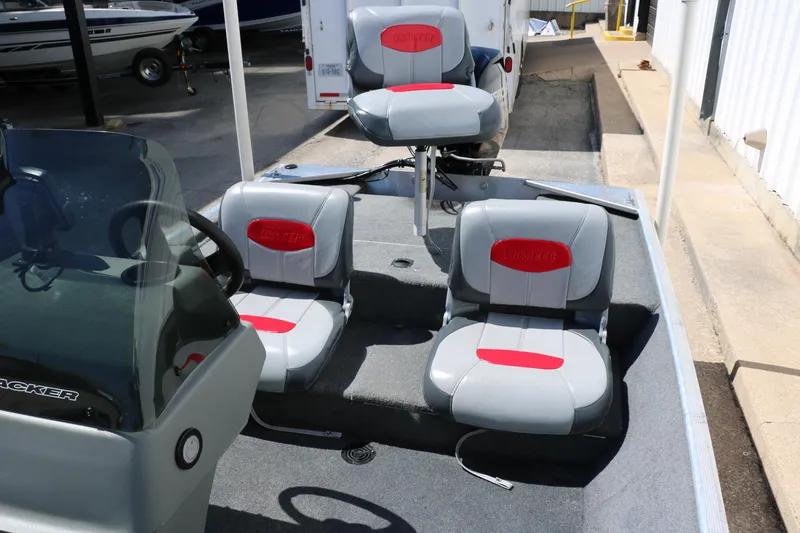 Slide: The Image of 2014 Tracker Pro 160 boat interior with three gray and red seats. - 23