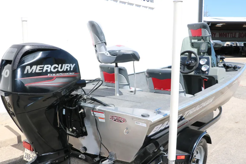 Slide: The Image of 2014 Tracker Pro 160 boat with Mercury FourStroke engine, parked outdoors. - 4