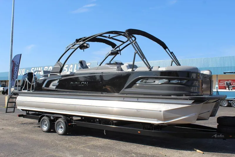 Slide: The Image of 2025 Avalon Excalibur LTD Quad Lounge 25 FT pontoon boat on trailer. - 1