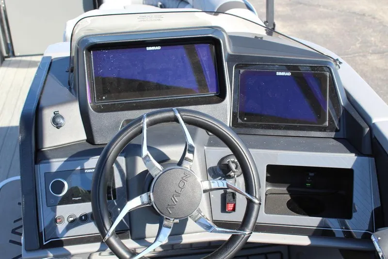 Slide: The Image of 2025 Avalon Excalibur LTD Quad Lounge dashboard with dual Simrad displays and steering wheel. - 14