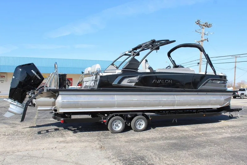 Slide: The Image of 2025 Avalon Excalibur LTD Quad Lounge 25 FT pontoon boat on trailer. - 2