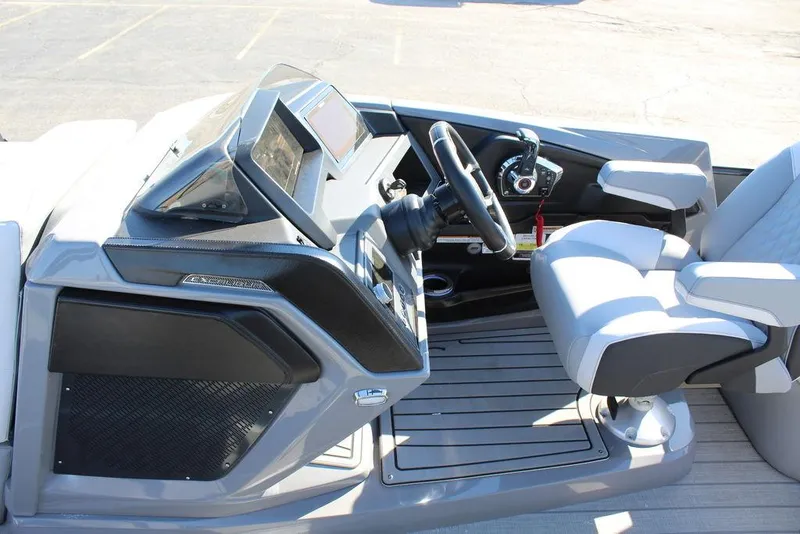 Slide: The Image of 2025 Avalon Excalibur LTD Quad Lounge 25 FT boat interior with modern helm and seating. - 22