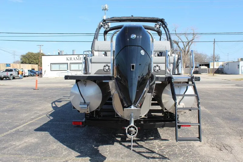 Slide: The Image of 2025 Avalon Excalibur LTD Quad Lounge 25 FT pontoon boat, rear view with motor and ladder. - 5