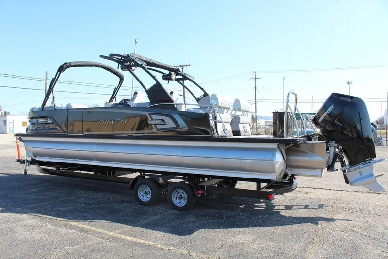 Slide: The Image of 2025 Avalon Excalibur LTD Quad Lounge 25 FT pontoon boat on trailer, side view. - 6