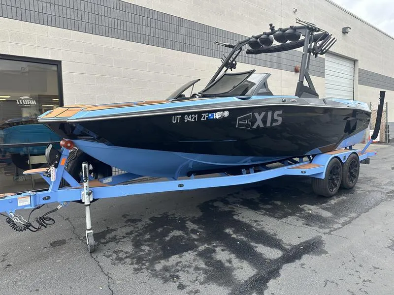 Slide: The Image of 2024 Axis A225 boat on trailer, parked outside a building. - 3