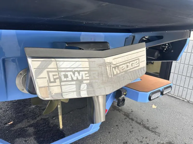 Slide: The Image of 2024 Axis A225 boat with Power Wedge feature, showcasing rear design and propeller. - 7