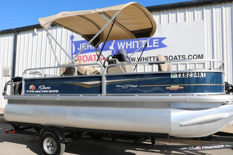 Slide: The Image of 2023 Sun Tracker Bass Buggy 18 DLX pontoon boat with canopy on trailer. - 12