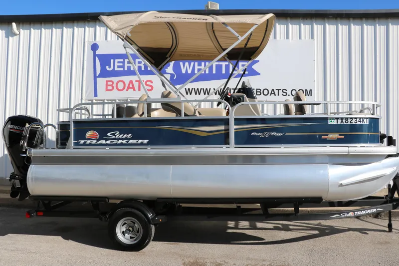 Slide: The Image of 2023 Sun Tracker Bass Buggy 18 DLX pontoon boat with canopy on trailer. - 13
