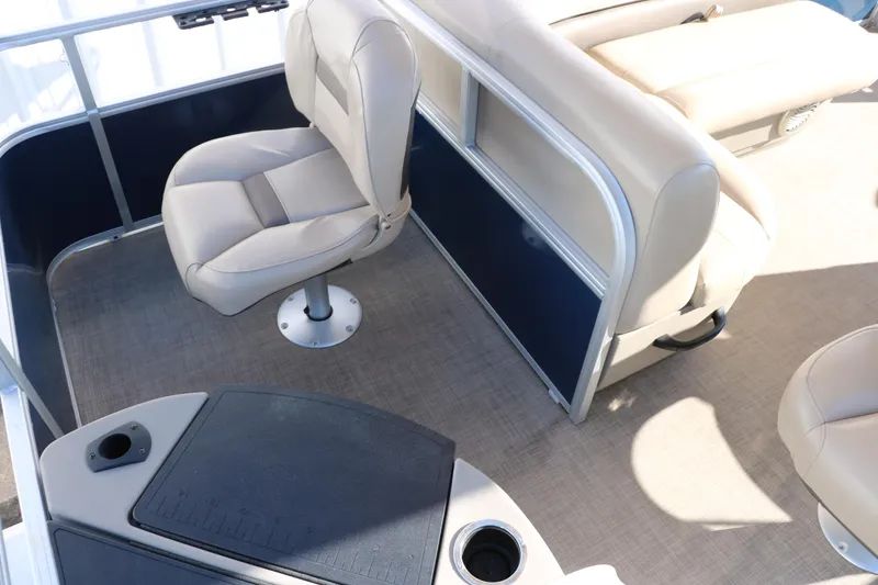 Slide: The Image of 2023 Sun Tracker Bass Buggy 18 DLX interior with beige seating and cup holders. - 19