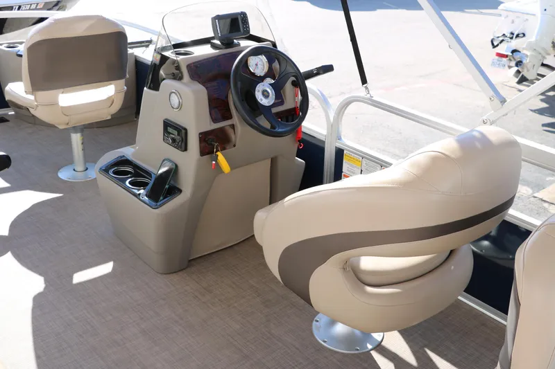 Slide: The Image of 2023 Sun Tracker Bass Buggy 18 DLX interior with steering console and seating. - 21