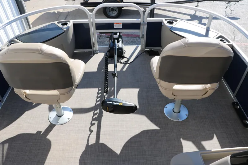 Slide: The Image of 2023 Sun Tracker Bass Buggy 18 DLX pontoon boat interior with two seats and trolling motor. - 26