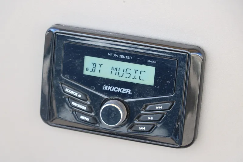 Slide: The Image of Kicker media center displaying "BT Music" on Sun Tracker Bass Buggy 18 DLX, 2023 model. - 31