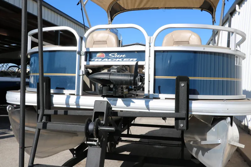 Slide: The Image of 2023 Sun Tracker Bass Buggy 18 DLX pontoon boat, blue exterior, docked in marina. - 8