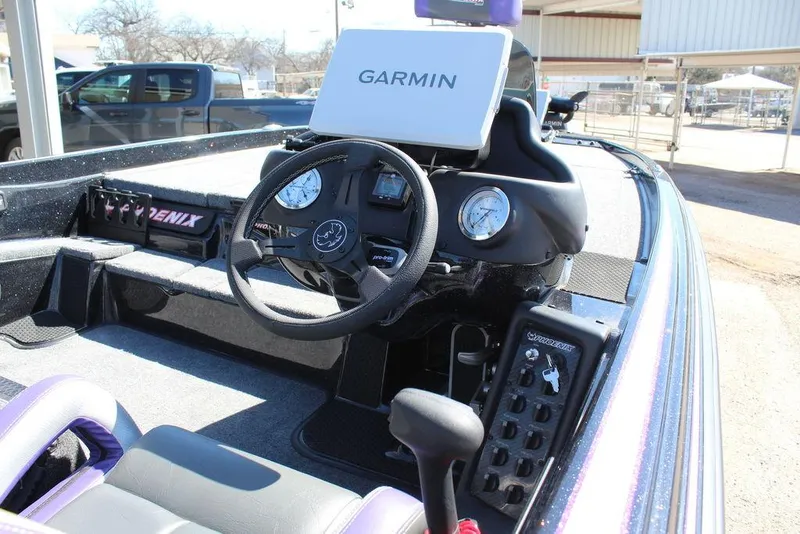 Slide: The Image of 2025 Phoenix 721 ZXL boat dashboard with Garmin navigation system and control panel. - 15