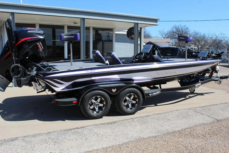 Slide: The Image of 2025 Phoenix 721 ZXL bass boat with dual axle trailer, parked outdoors. - 3