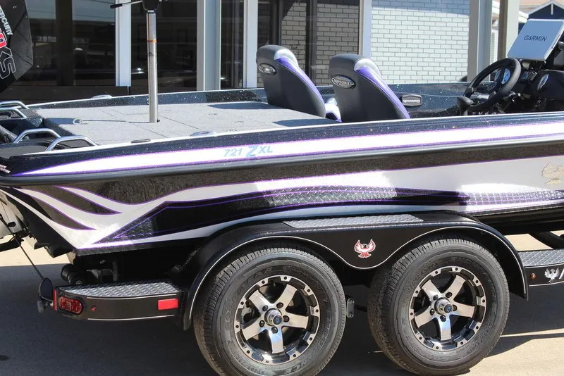 Slide: The Image of 2025 Phoenix 721 ZXL boat with sleek design and dual-axle trailer. - 4