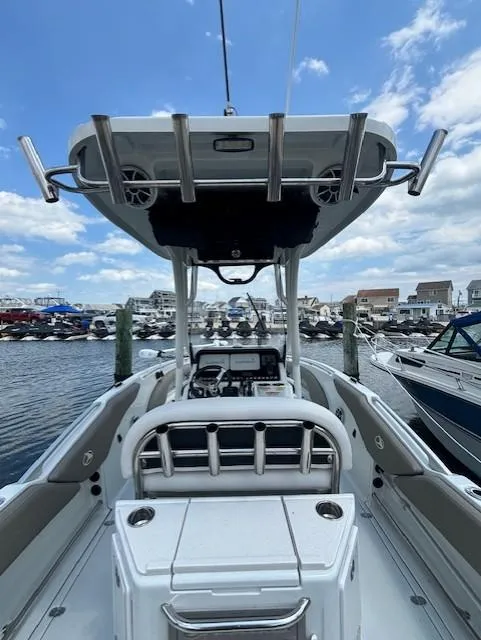 Slide: The Image of 2022 Finseeker 230 CC boat docked at marina, showcasing helm and seating area. - 18