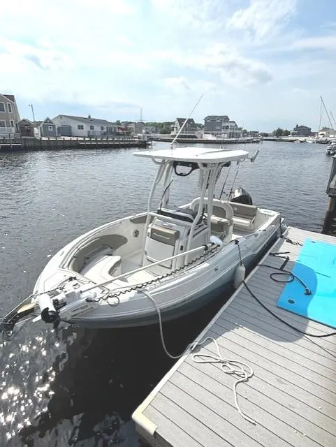 Slide: The Image of 2022 Finseeker 230 CC boat docked at a marina under a clear sky. - 4