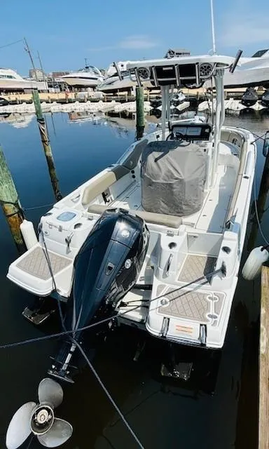 Slide: The Image of 2022 Finseeker 230 CC boat docked in marina, featuring outboard motor and sleek design. - 5