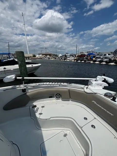 Slide: The Image of 2022 Finseeker 230 CC boat docked at marina under cloudy sky. - 6
