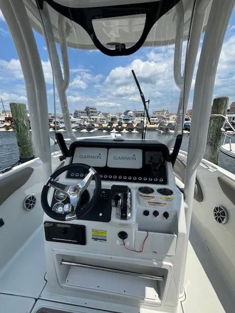 Slide: The Image of 2022 Finseeker 230 CC boat cockpit with Garmin navigation, docked at marina. - 7
