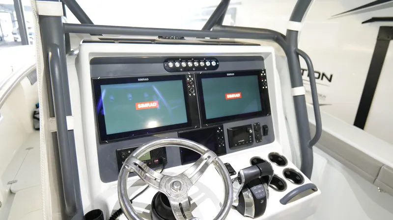 Slide: The Image of 2022 Yellowfin 34 boat dashboard with dual Simrad displays and steering wheel. - 15