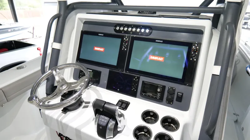 Slide: The Image of 2022 Yellowfin 34 boat dashboard with dual Simrad displays and steering wheel. - 16