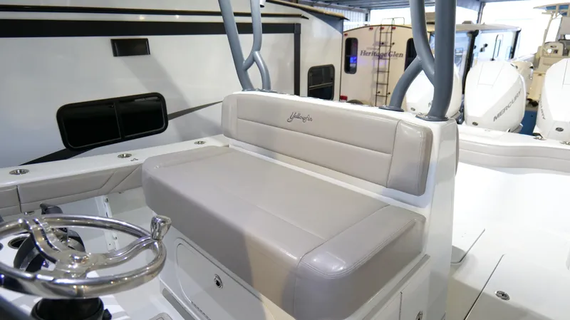 Slide: The Image of 2022 Yellowfin 34 boat interior with cushioned seating and steering wheel. - 19