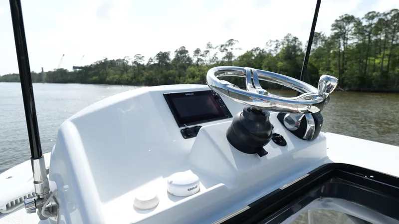 Slide: The Image of 2022 Yellowfin 34 boat helm with steering wheel and navigation display. - 21