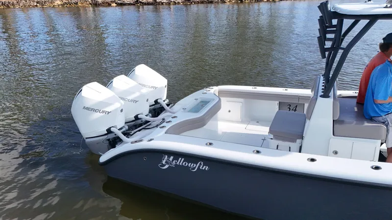 Slide: The Image of 2022 Yellowfin 34 boat with twin Mercury engines on calm water. - 26