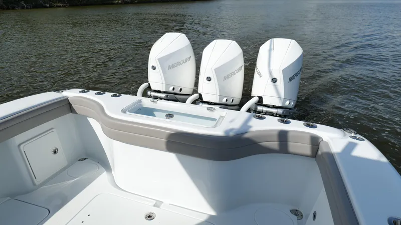 Slide: The Image of 2022 Yellowfin 34 boat with triple Mercury outboard engines on calm water. - 29