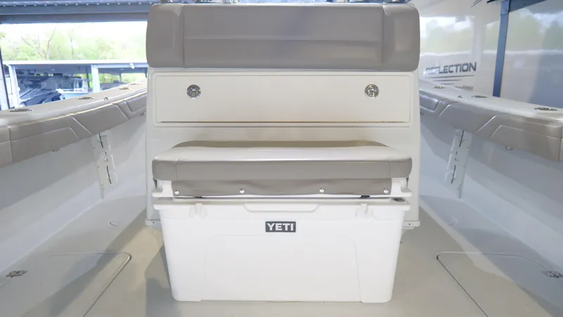 Slide: The Image of 2022 Yellowfin 34 boat interior with Yeti cooler and cushioned seating. - 34